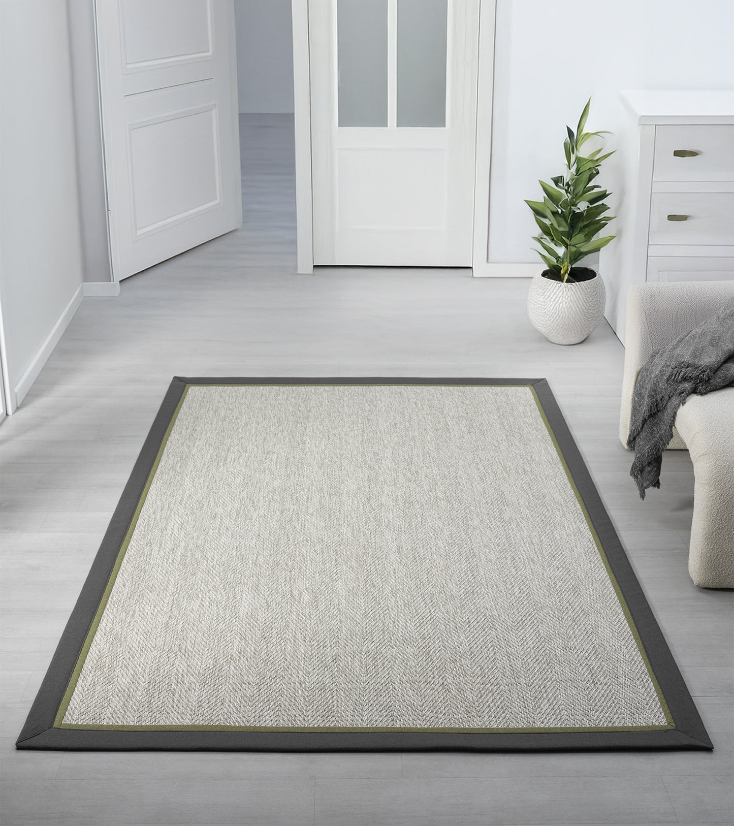Modern bir oturma odasında yer alan sisal halı, minimalist tasarımı ve şık bordürü ile mekanın ortasında serili.